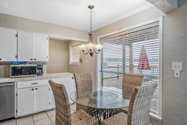107 Oak Acres Dr W, Malakoff, TX 75148 - dining area with a chandelier, a textured wall, light tile patterned floors, and ornamental molding