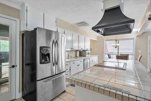 107 Oak Acres Dr W, Malakoff, TX 75148 - kitchen with stainless steel appliances, custom range hood, tile counters, and healthy amount of natural light