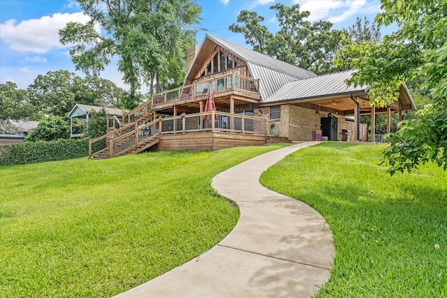 107 Oak Acres Dr W, Malakoff, TX 75148 - back of house featuring a lawn, metal roof, a chimney, and a wooden deck