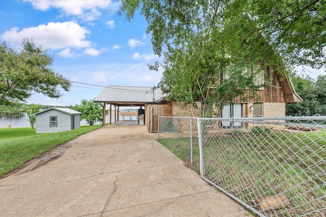107 Oak Acres Dr W, Malakoff, TX 75148 - view of front of home with driveway, brick siding, a detached carport, and metal roof