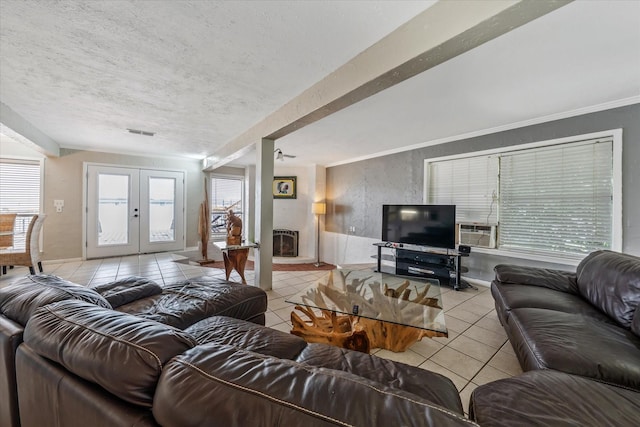 107 Oak Acres Dr W, Malakoff, TX 75148 - living area featuring light tile patterned floors, french doors, cooling unit, a textured ceiling, and heating unit