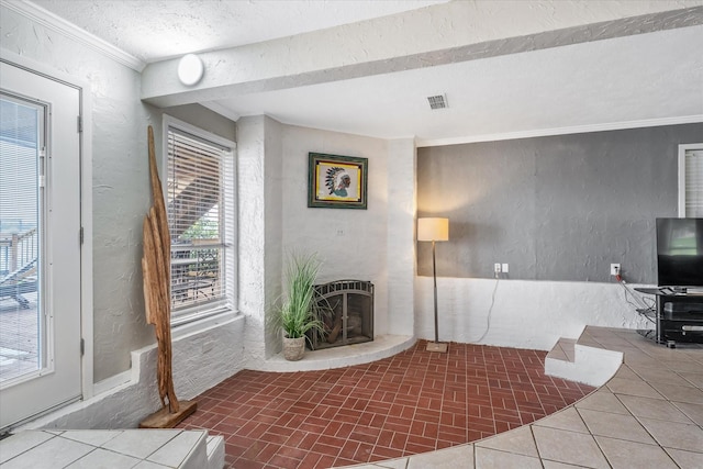 107 Oak Acres Dr W, Malakoff, TX 75148 - unfurnished living room featuring a brick fireplace, ornamental molding, and a textured wall