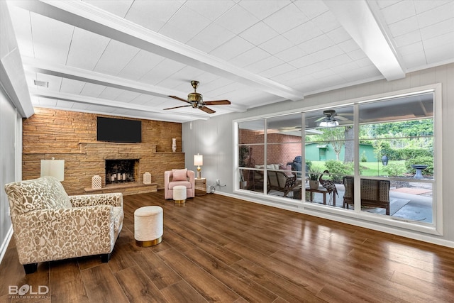 5918 Fern Ave, Shreveport, LA 71105 - living room featuring a ceiling fan, beam ceiling, wood finished floors, a stone fireplace, and wood walls