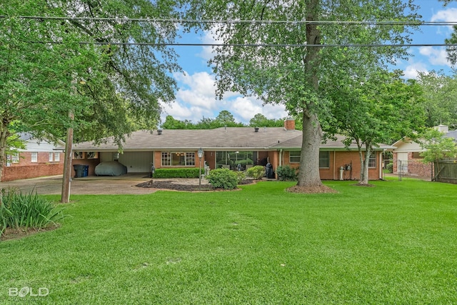 5918 Fern Ave, Shreveport, LA 71105 - rear view of house featuring a chimney, driveway, and a carport