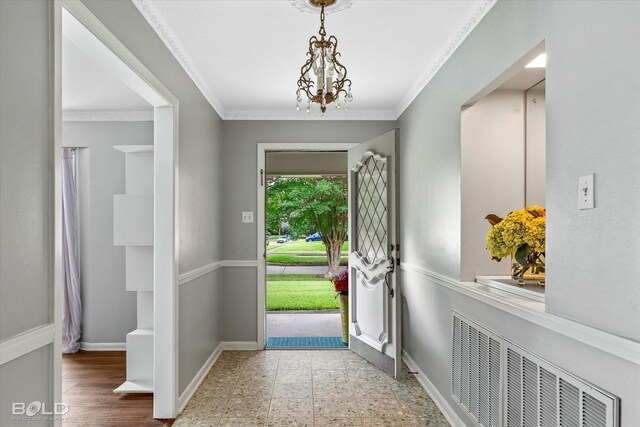 5918 Fern Ave, Shreveport, LA 71105 - foyer entrance with a chandelier, baseboards, crown molding, and radiator heating unit
