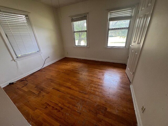 143 Brookshire Ave, Azle, TX 76020 - unfurnished bedroom featuring wood finished floors and baseboards