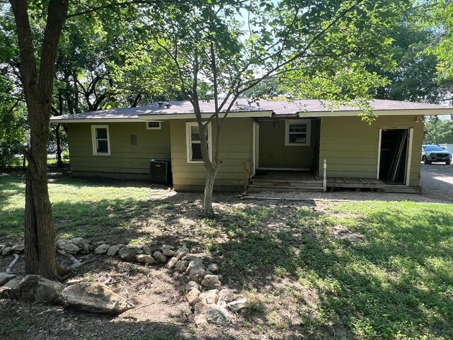 143 Brookshire Ave, Azle, TX 76020 - rear view of property featuring central air condition unit and a lawn