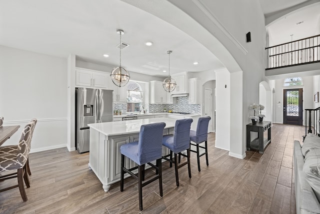 316 Cunningham Cir, Celina, TX 75009 - kitchen with stainless steel refrigerator with ice dispenser, light countertops, a kitchen island, healthy amount of natural light, and recessed lighting