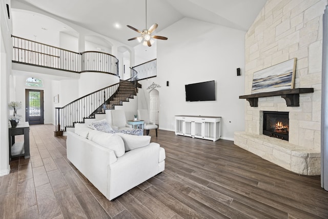 316 Cunningham Cir, Celina, TX 75009 - living area with high vaulted ceiling, a ceiling fan, stairs, dark wood-type flooring, and a stone fireplace