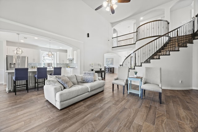 316 Cunningham Cir, Celina, TX 75009 - living area featuring stairway, a ceiling fan, dark wood finished floors, arched walkways, and baseboards