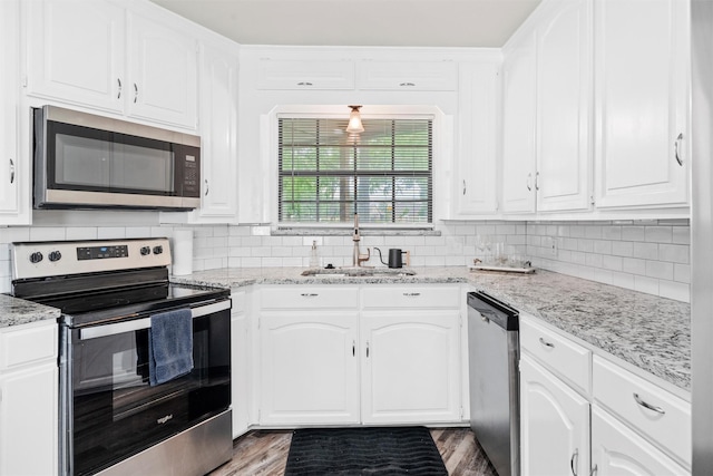 13340 Willow Springs Rd, Haslet, TX 76052 - kitchen featuring stainless steel appliances, a sink, white cabinetry, and backsplash