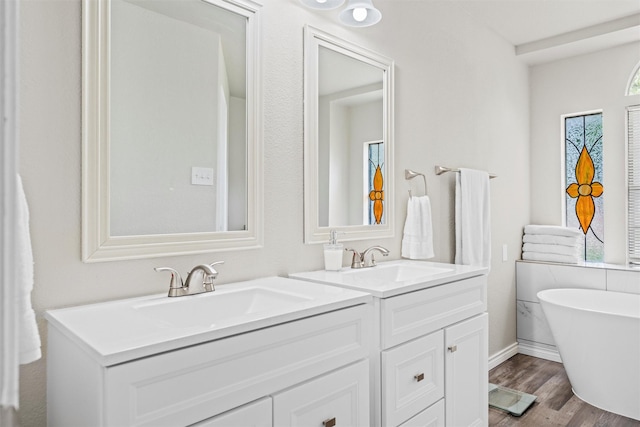 13340 Willow Springs Rd, Haslet, TX 76052 - full bath with double vanity, wood finished floors, a freestanding tub, and baseboards