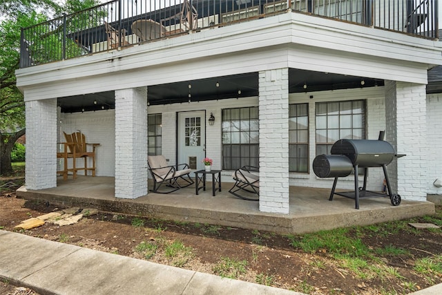 13340 Willow Springs Rd, Haslet, TX 76052 - view of exterior entry featuring a balcony, brick siding, and covered porch