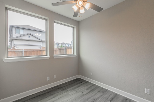 2033 Barbette St, Fort Worth, TX 76008 - spare room with wood finished floors, baseboards, and a ceiling fan