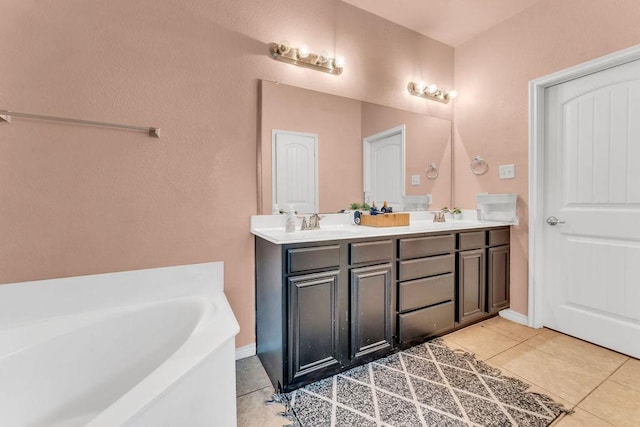 5605 Cojimar Dr, Mckinney, TX 75070 - bathroom with double vanity, a bath, and tile patterned flooring