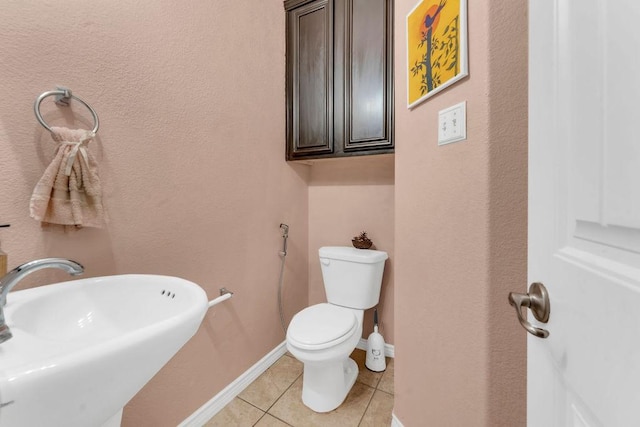 5605 Cojimar Dr, Mckinney, TX 75070 - half bathroom featuring a sink, tile patterned floors, toilet, and baseboards