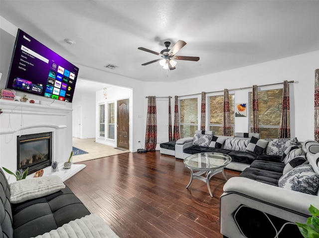 5605 Cojimar Dr, Mckinney, TX 75070 - living area with a ceiling fan, wood finished floors, and a glass covered fireplace