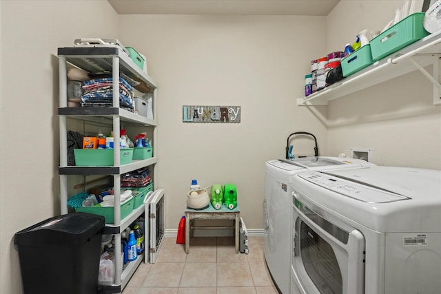 11521 Misty Mesa Dr, Fort Worth, TX 76052 - laundry room featuring washer and dryer and light tile patterned floors