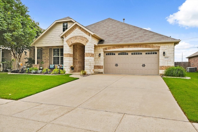11521 Misty Mesa Dr, Fort Worth, TX 76052 - french provincial home with stone siding, a front lawn, a garage, and cooling unit