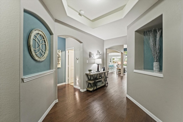 11521 Misty Mesa Dr, Fort Worth, TX 76052 - corridor with arched walkways, wood finished floors, baseboards, and a tray ceiling