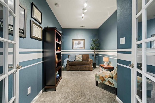 11521 Misty Mesa Dr, Fort Worth, TX 76052 - living area with french doors, carpet floors, and rail lighting