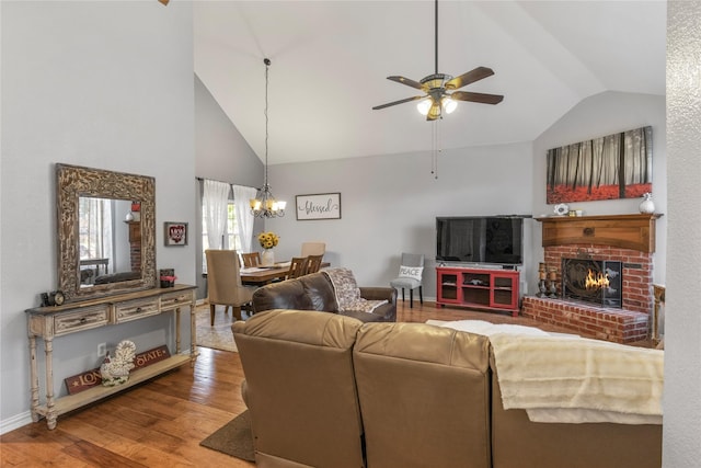 4425 Maple Shade Ave, Sachse, TX 75048 - living room featuring wood finished floors, ceiling fan, high vaulted ceiling, a chandelier, and a brick fireplace