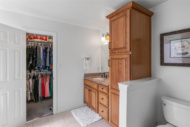 4425 Maple Shade Ave, Sachse, TX 75048 - bathroom featuring vanity, tile patterned floors, toilet, and a walk in closet