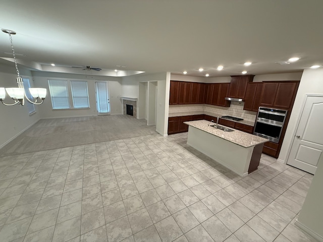 3681 Keechi Creek Dr, Celina, TX 75078 - kitchen featuring ceiling fan, backsplash, a sink, under cabinet range hood, and recessed lighting