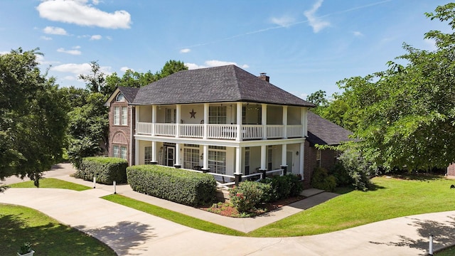 720 Aqua Vista Dr, Granbury, TX 76049 - rear view of property featuring a porch, a balcony, a yard, brick siding, and roof with shingles