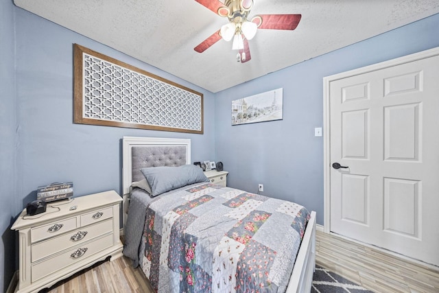 720 Aqua Vista Dr, Granbury, TX 76049 - bedroom featuring light wood finished floors, ceiling fan, and a textured ceiling