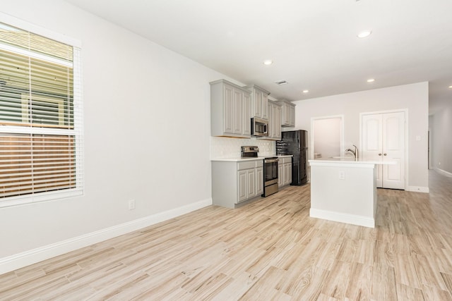8409 Alba Ln, Rowlett, TX 75089 - kitchen featuring appliances with stainless steel finishes, gray cabinetry, light countertops, light wood finished floors, and recessed lighting