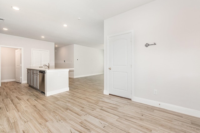 8409 Alba Ln, Rowlett, TX 75089 - kitchen with an island with sink, light wood finished floors, light countertops, recessed lighting, and baseboards