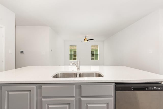 8409 Alba Ln, Rowlett, TX 75089 - kitchen with stainless steel dishwasher, a sink, a ceiling fan, and gray cabinetry