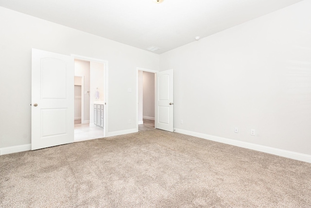 8409 Alba Ln, Rowlett, TX 75089 - unfurnished bedroom with light colored carpet, baseboards, and connected bathroom