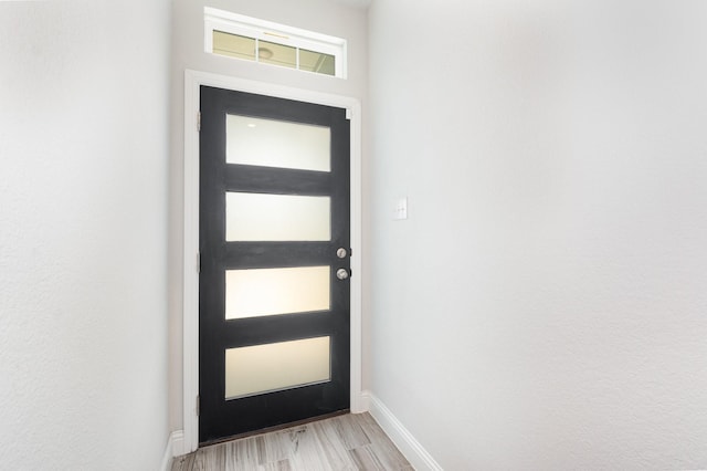 8409 Alba Ln, Rowlett, TX 75089 - doorway to outside featuring light wood-type flooring and baseboards