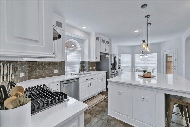 566 Long Meadow Dr, Haslet, TX 76052 - kitchen featuring appliances with stainless steel finishes, white cabinets, glass insert cabinets, light countertops, and recessed lighting