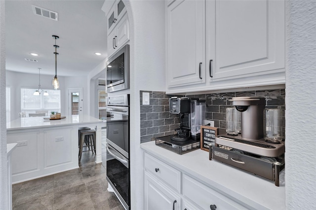 566 Long Meadow Dr, Haslet, TX 76052 - kitchen featuring stainless steel appliances, decorative backsplash, white cabinetry, light countertops, and hanging light fixtures