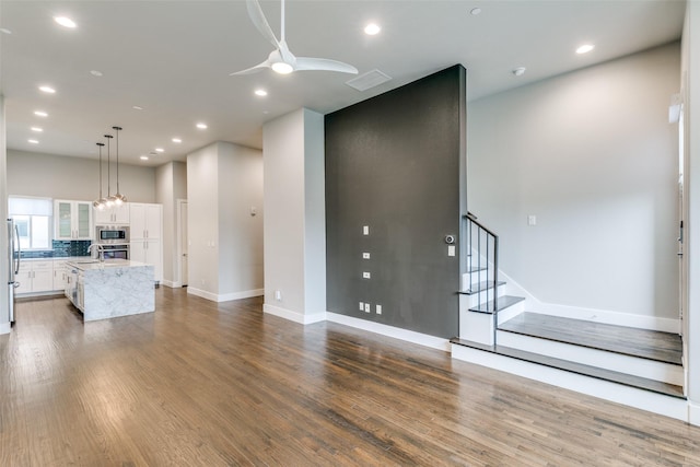 3816 Roseland Ave Unit C200, Dallas, TX 75204 - unfurnished living room featuring a ceiling fan, dark wood-type flooring, stairs, and recessed lighting