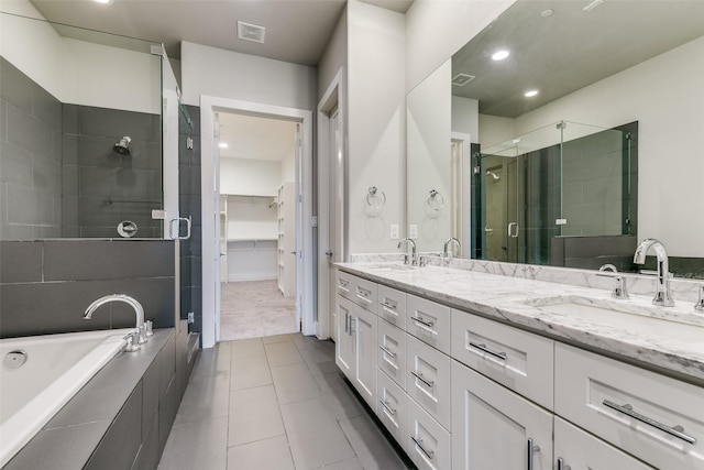 3816 Roseland Ave Unit C200, Dallas, TX 75204 - full bathroom with a stall shower, double vanity, a garden tub, tile patterned floors, and a walk in closet