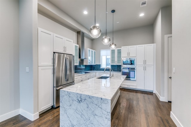 3816 Roseland Ave Unit C200, Dallas, TX 75204 - kitchen with appliances with stainless steel finishes, wall chimney exhaust hood, glass insert cabinets, an island with sink, and white cabinetry