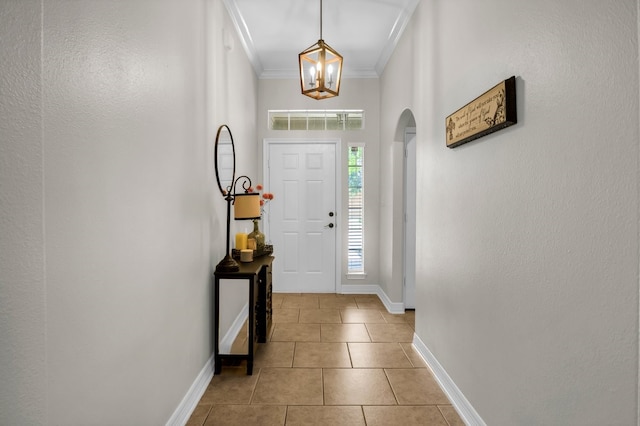 229 Maggie Cir, Flint, TX 75762 - foyer entrance with baseboards, arched walkways, light tile patterned flooring, crown molding, and a chandelier