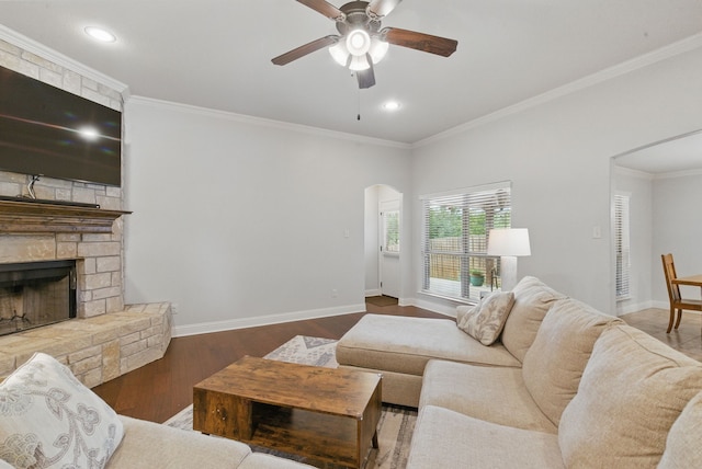 616 Zachary Dr, Weatherford, TX 76087 - living area with arched walkways, ceiling fan, baseboards, a fireplace, and crown molding