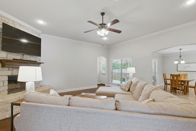616 Zachary Dr, Weatherford, TX 76087 - living room with arched walkways, ornamental molding, a ceiling fan, baseboards, and recessed lighting