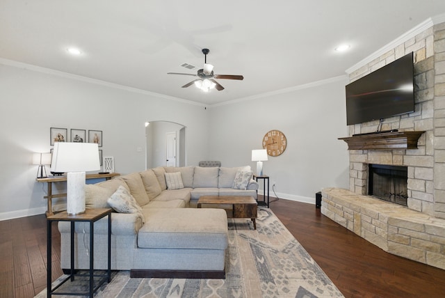 616 Zachary Dr, Weatherford, TX 76087 - living room featuring arched walkways, baseboards, a ceiling fan, a fireplace, and crown molding