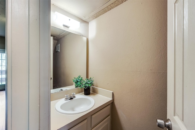 9801 Royal Ln Unit 703, Dallas, TX 75231 - bathroom with vanity and a textured wall