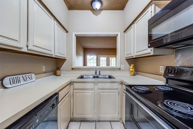 9801 Royal Ln Unit 703, Dallas, TX 75231 - kitchen with black appliances, light countertops, a sink, and white cabinets