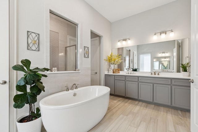 925 Glen Lake Dr, Southlake, TX 76092 - bathroom featuring a soaking tub, double vanity, and a shower with shower door
