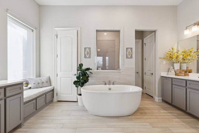 925 Glen Lake Dr, Southlake, TX 76092 - bathroom with vanity, a soaking tub, and wood finished floors