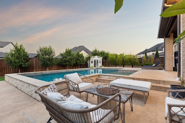 925 Glen Lake Dr, Southlake, TX 76092 - pool at dusk with a fenced backyard, a patio, and a storage shed
