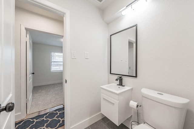 509 Twilight Dr, Garland, TX 75040 - half bathroom with vanity, toilet, and tile patterned flooring